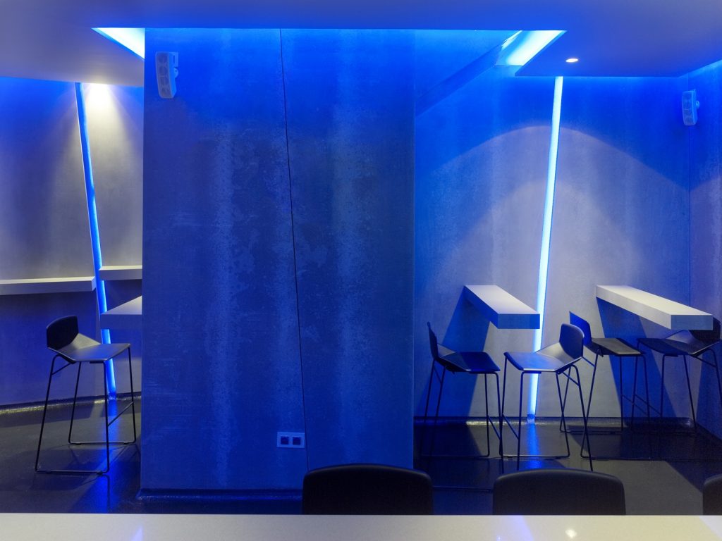 Mesas altas y detalles inclinados en diseño de La Fragua de Vulcano Lounge & Bar